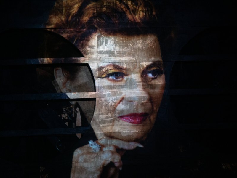 Digital portrait of a woman with golden eyeshadow and red lips, fragmented by horizontal dark bands.