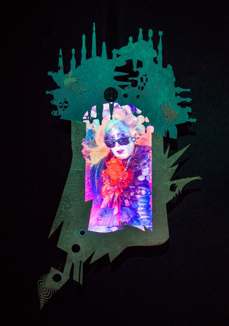A vibrant, distorted portrait of a person in sunglasses and a lei, projected onto a green, abstract, cutout shape.